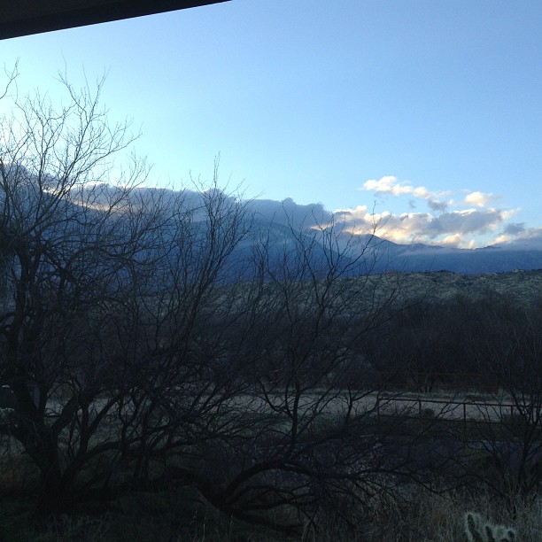 the mountains are seen from a balcony in the winter