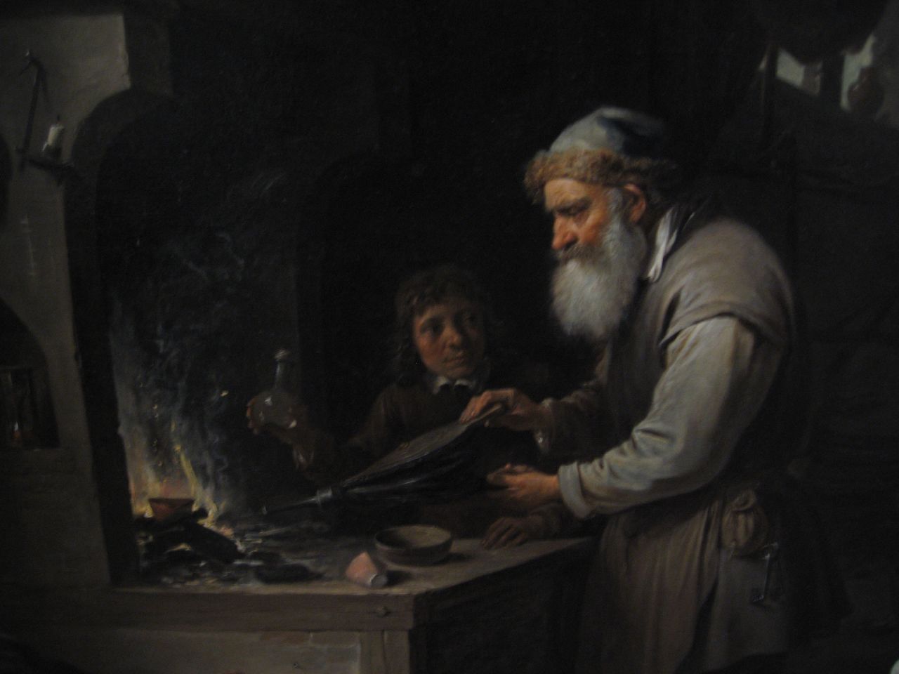 a man cooking with a woman and boy in a kitchen