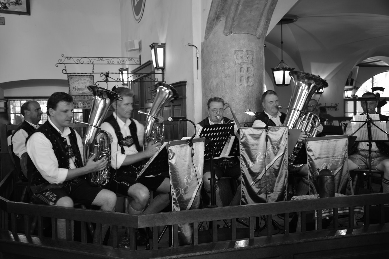 a group of musicians play in an ornate building