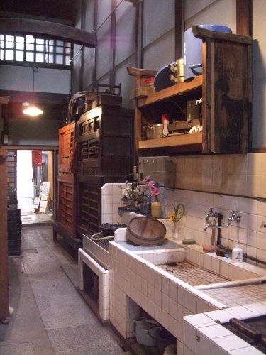 an old kitchen with cabinets, shelves and drawers