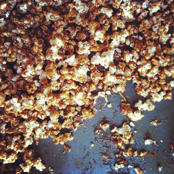 a mixture of caramel popcorn on the side of a table
