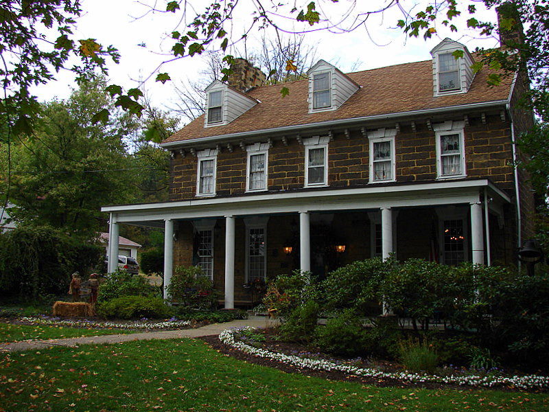 a large house with a porch and several windows