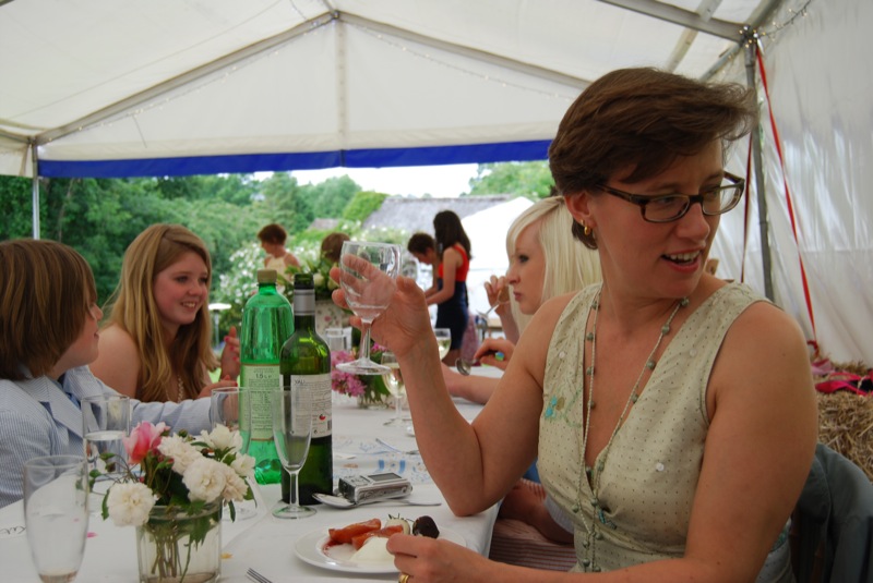 a group of women standing around at a table