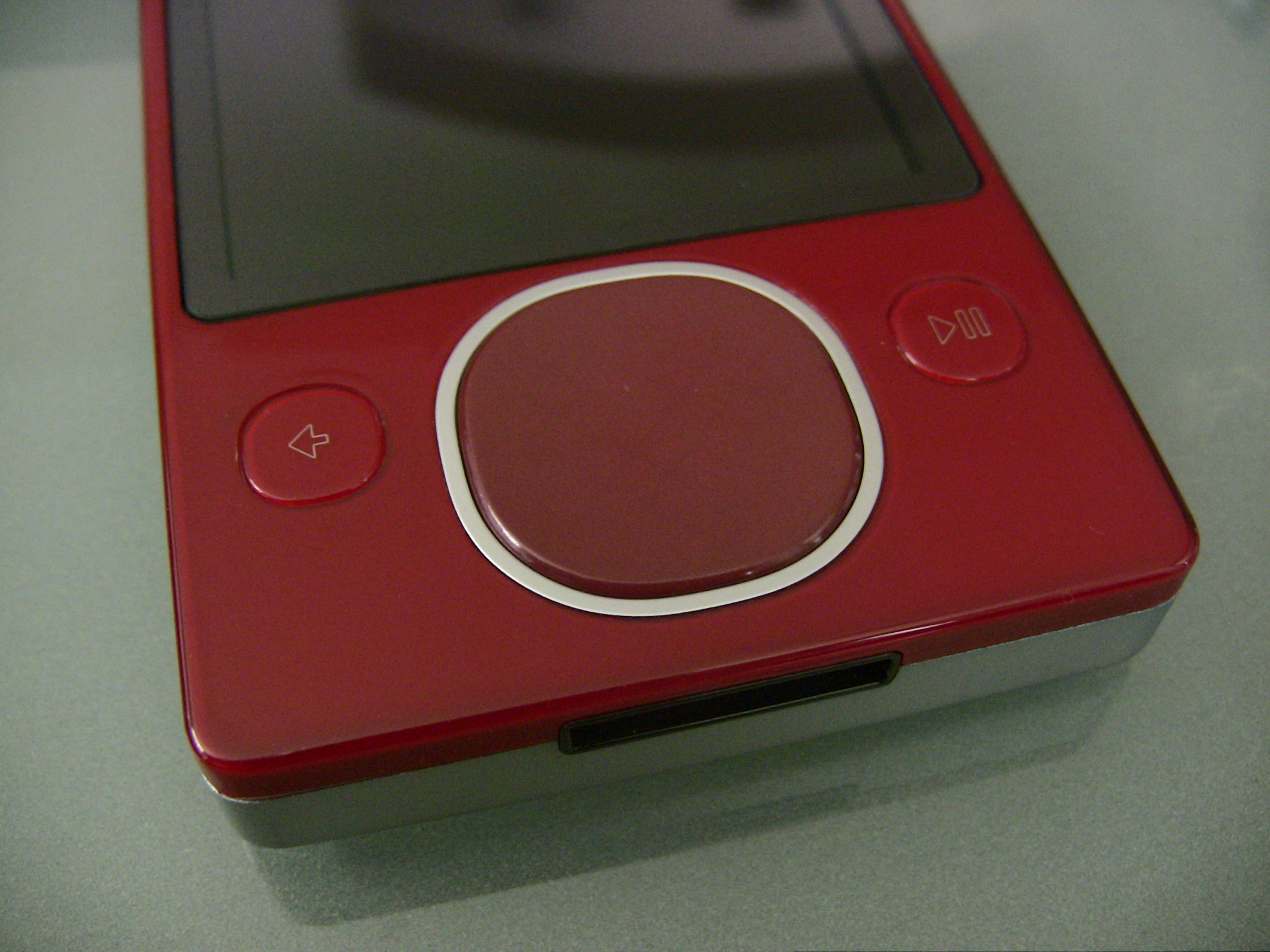 there is an old red cell phone sitting on the counter