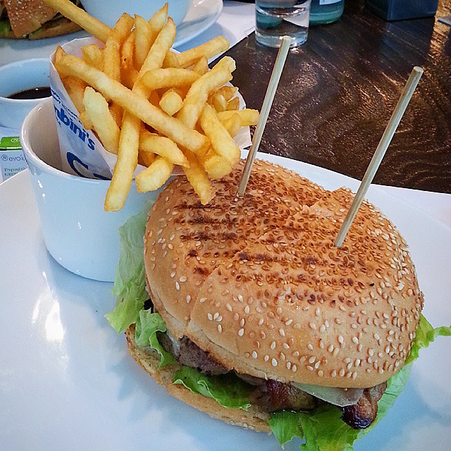 hamburger with french fries on white plate on table