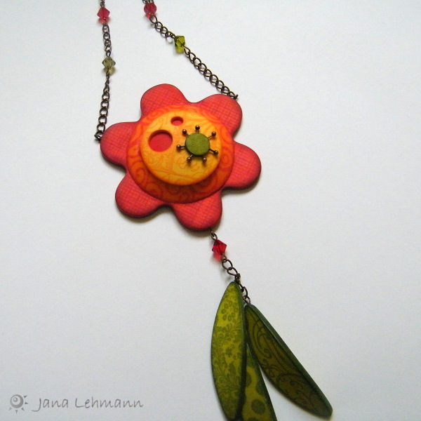a flower shaped object on a metal chain