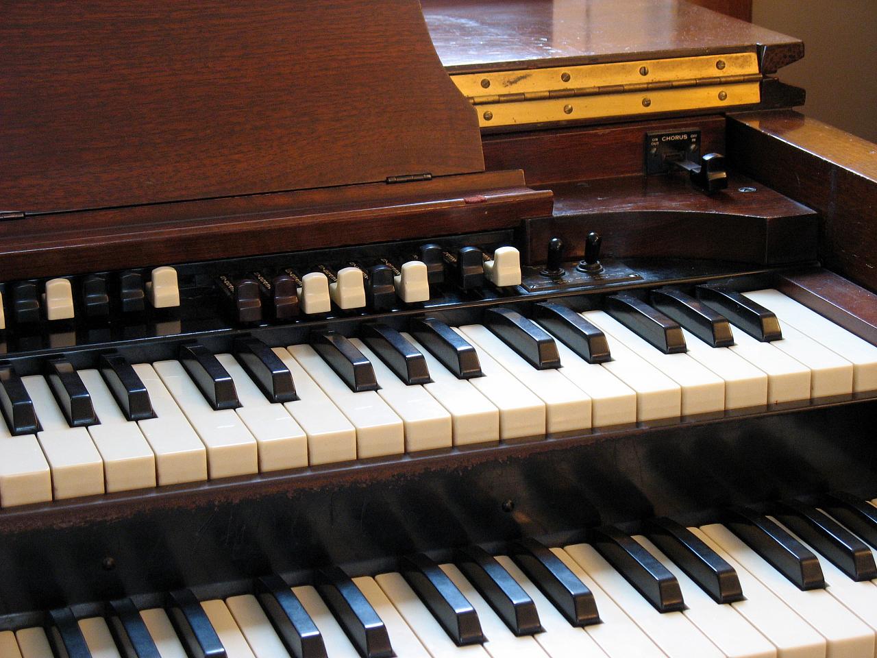 a closeup s of the keys and s on an organ