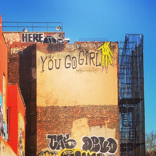 graffiti on the side of a building, with the words you're girl