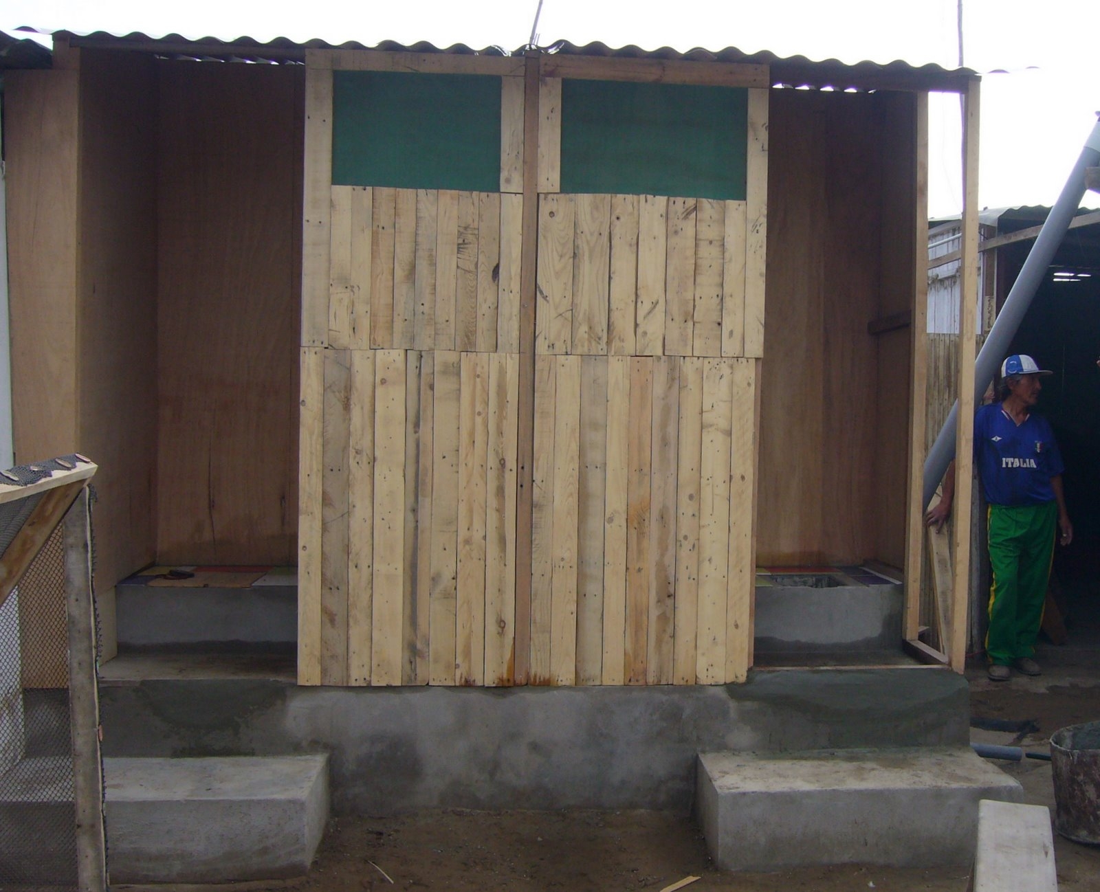 a person is in front of a shed with some wood shingles