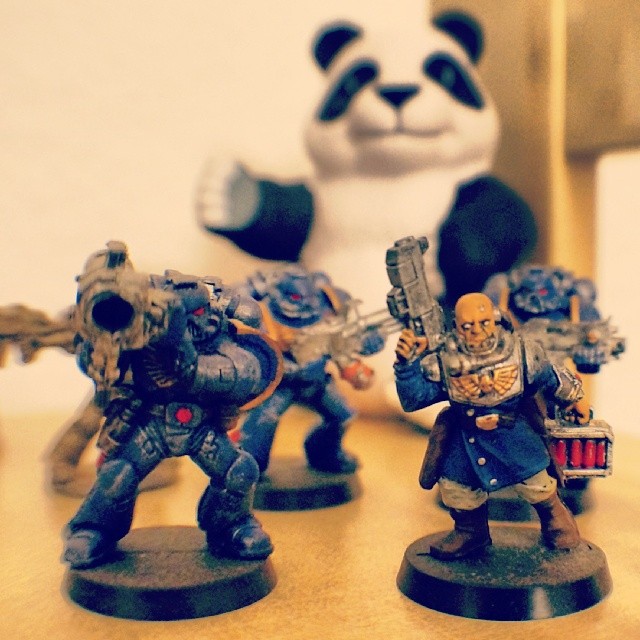 three warhammers with painted faces on them and two panda bears