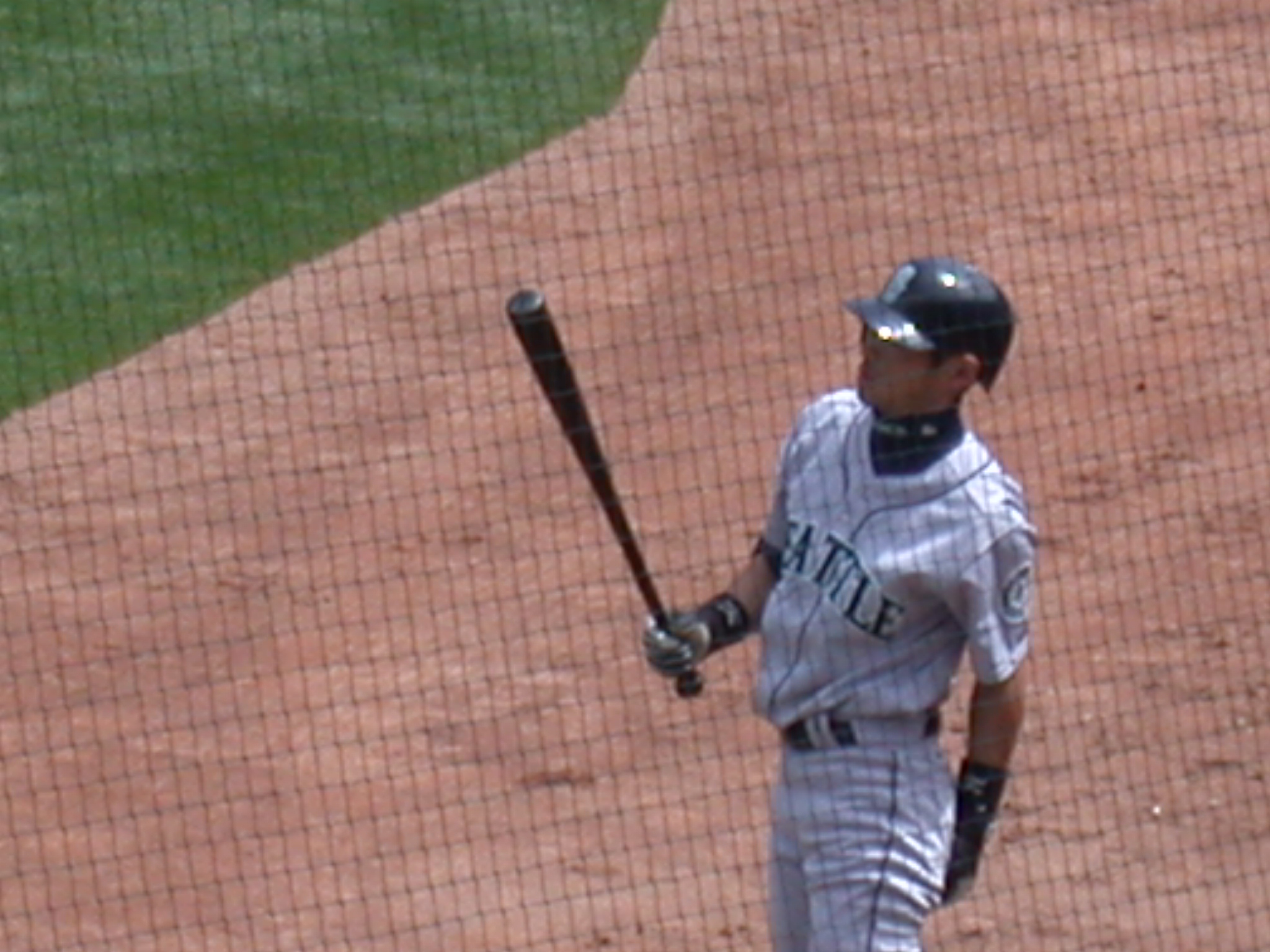 a man holding a baseball bat on a field