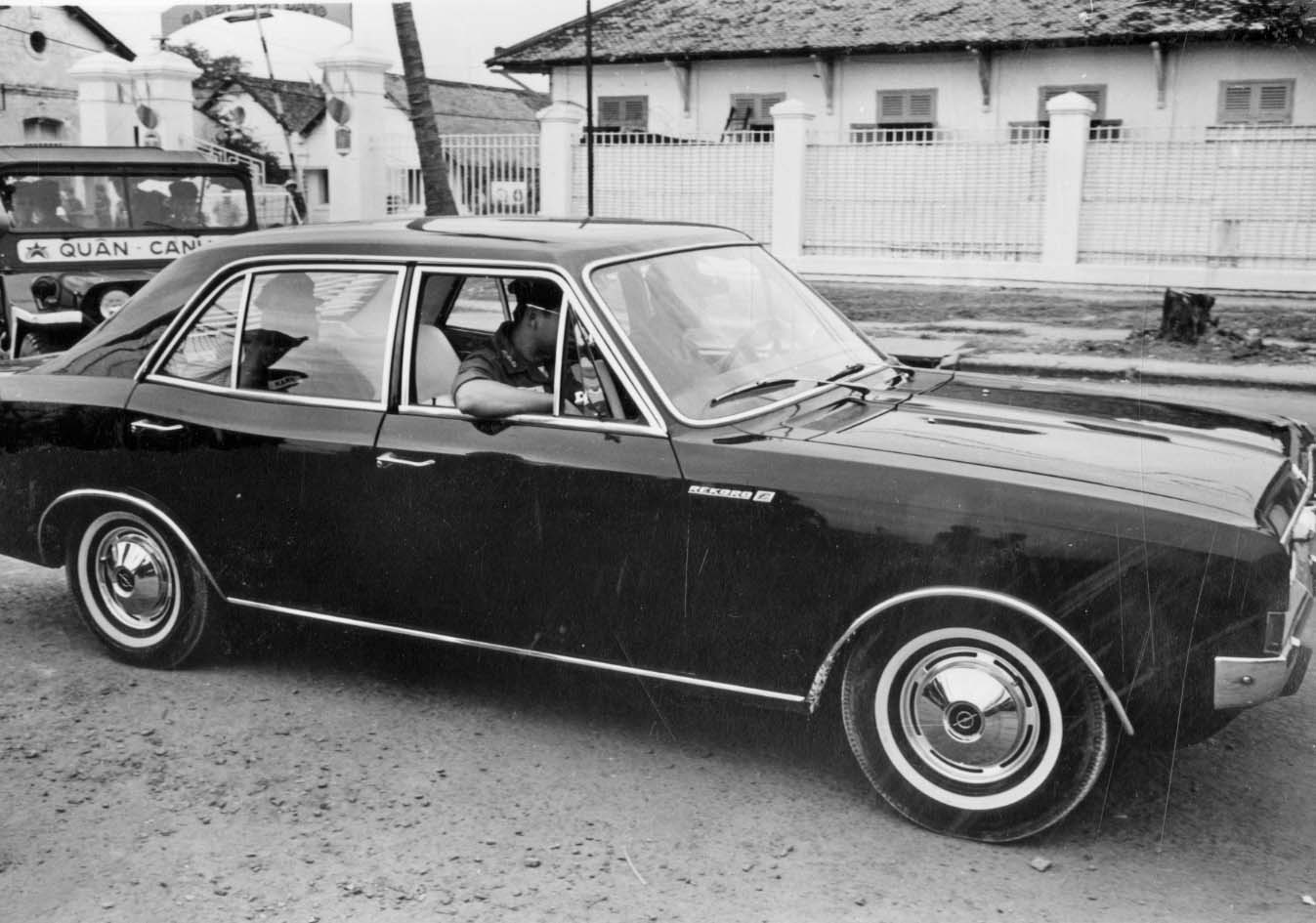 a classic car on the street with other cars