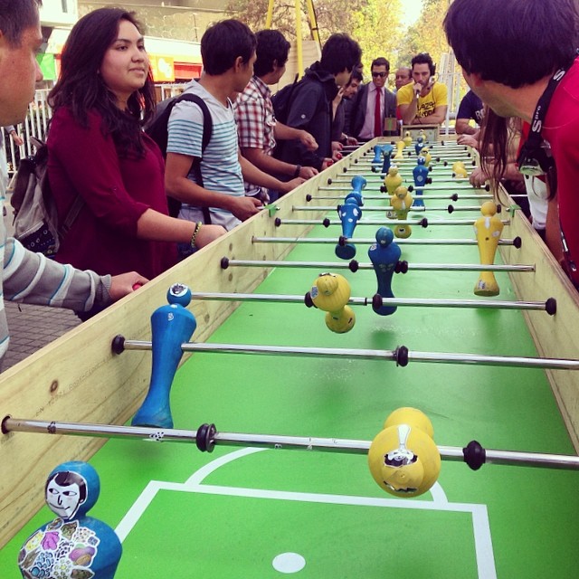 several people standing by a line of foo - ball games