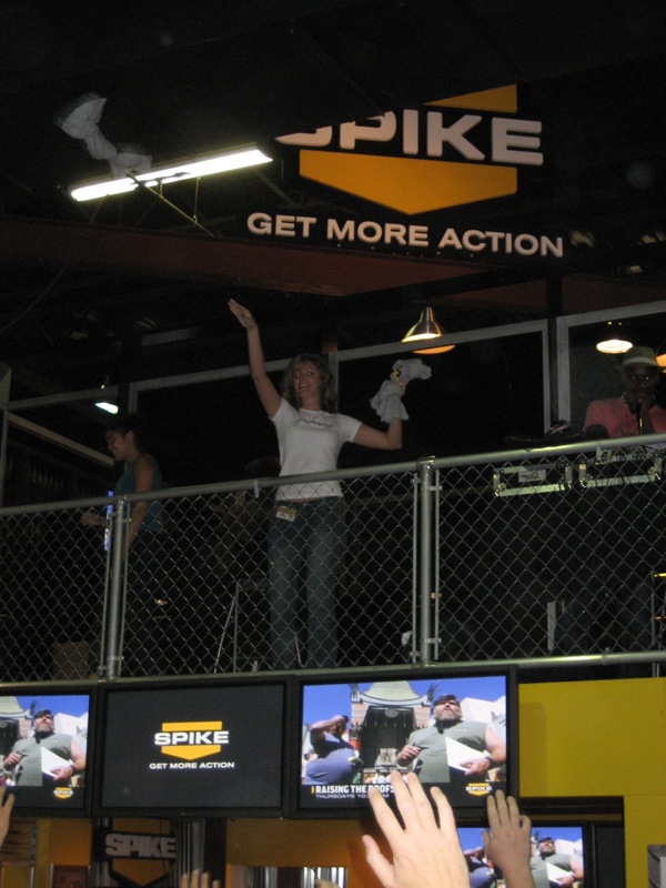 people at a fake football stadium with their arms in the air