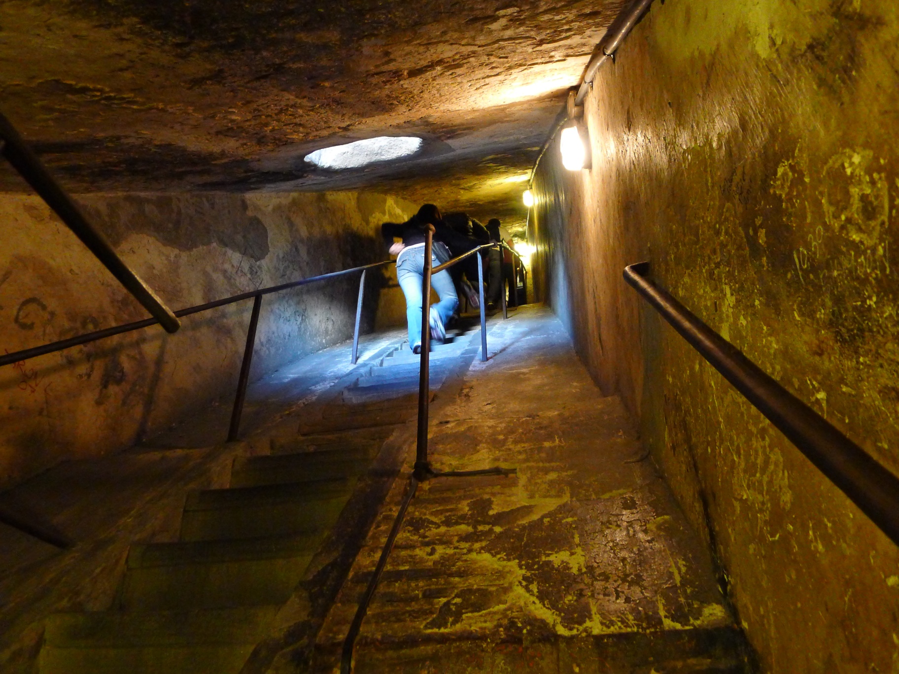 an underground staircase with lights shining in the dark