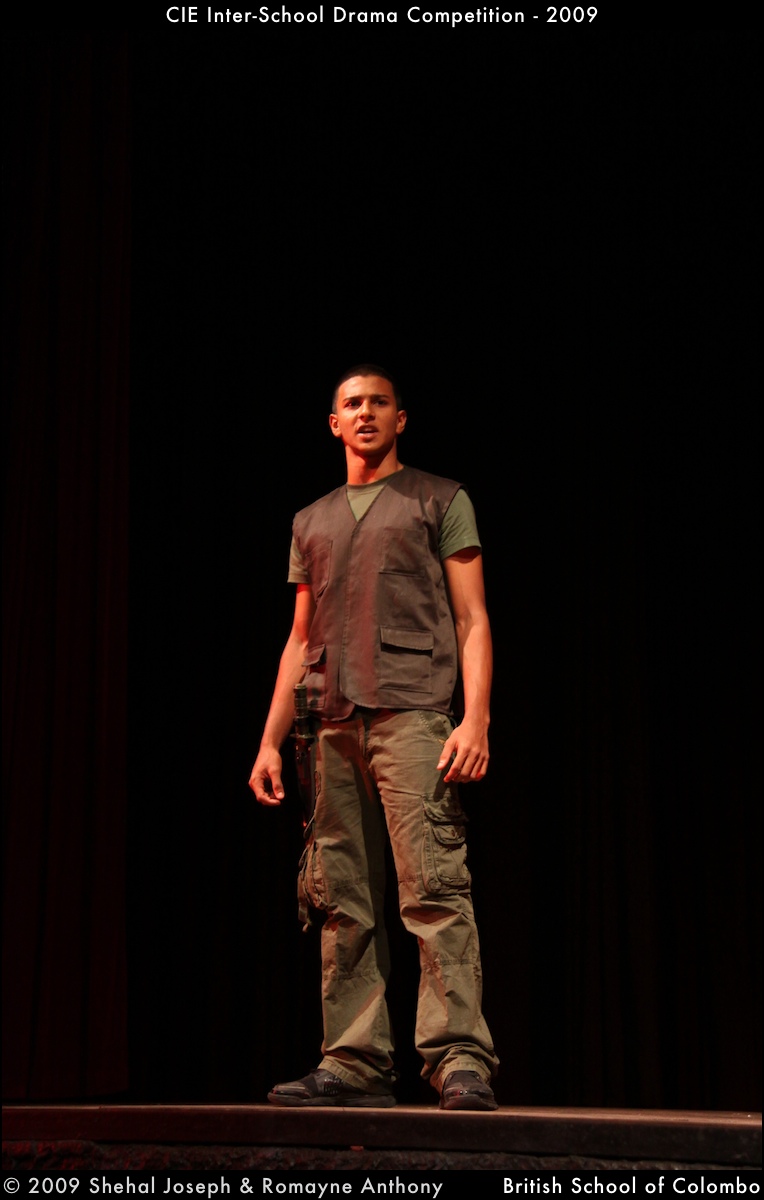 a man in a vest standing on stage