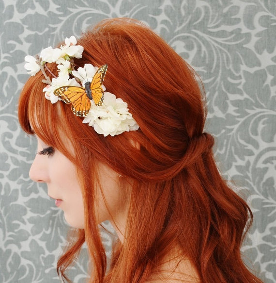 a woman with red hair and a erfly hair accessory