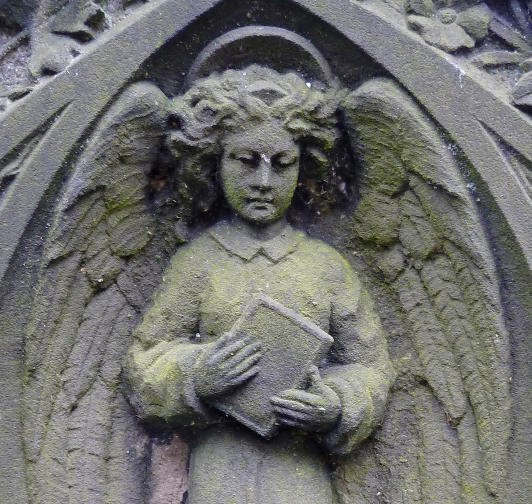 an angel statue in front of a stone building