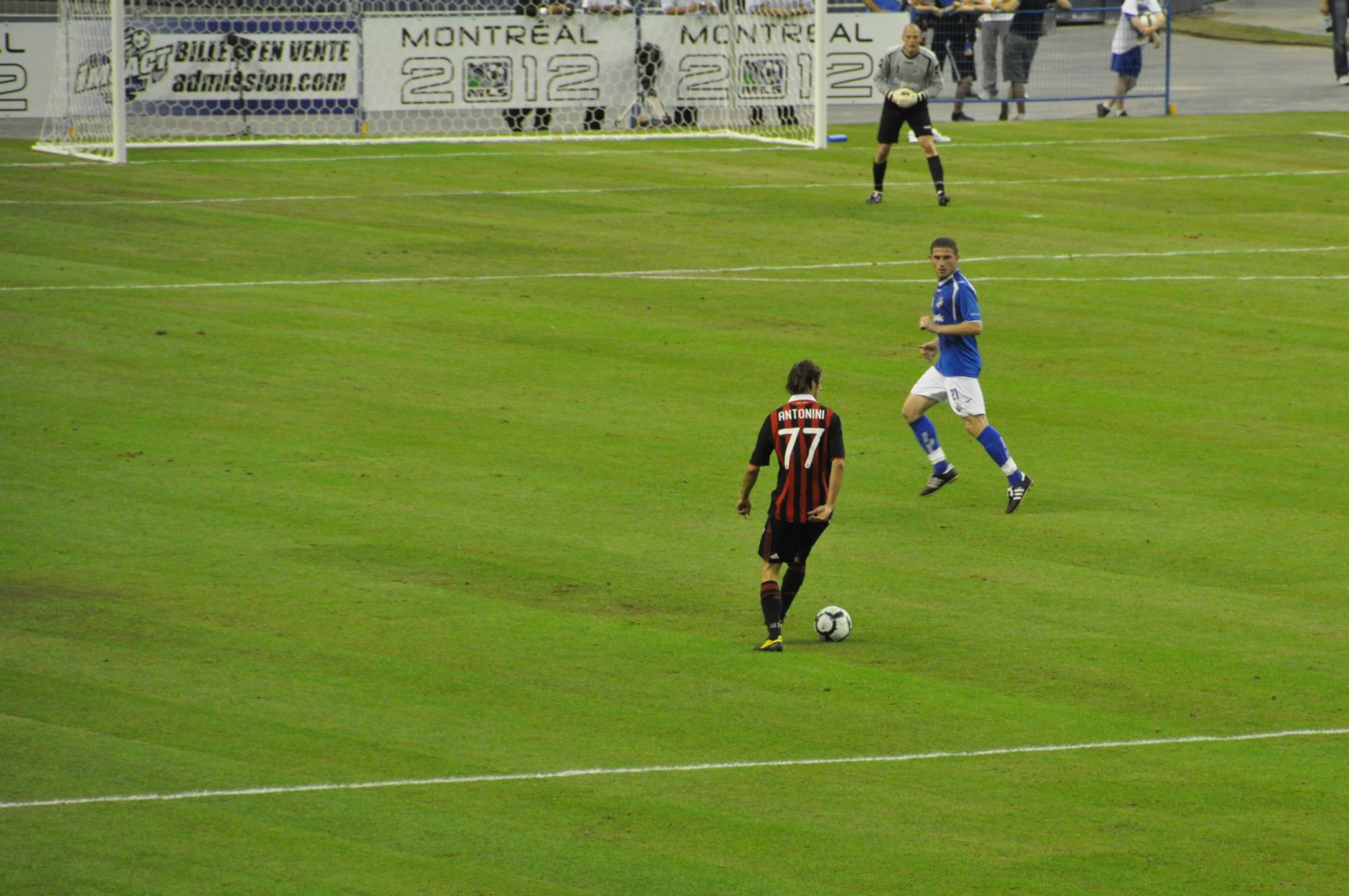 a group of people play soccer on a field