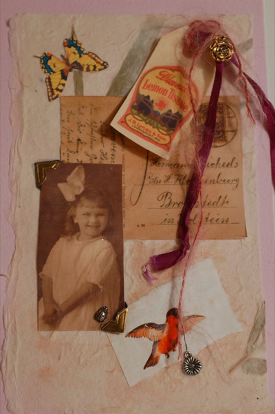 altered postcard with papers, magnets and small cards