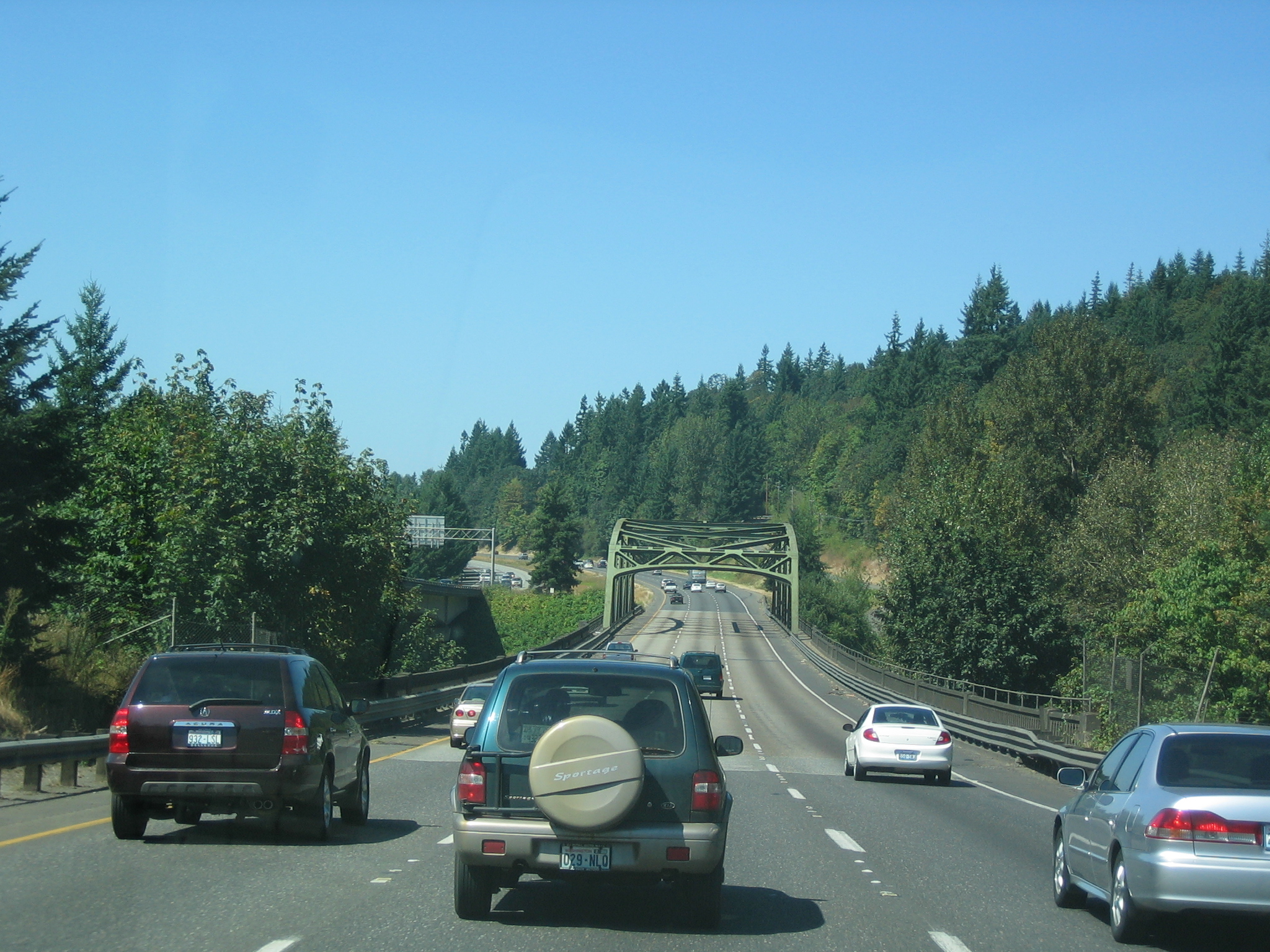 a line of cars travel down a highway