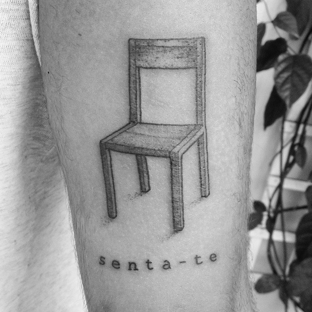 a chair on the arm saying sentate with an artistically marked message