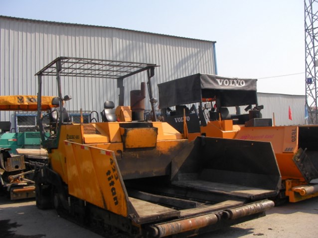 the back end of construction equipment in front of a building
