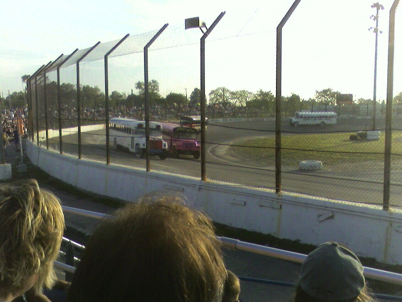 a group of people watching a race at a motor racing track