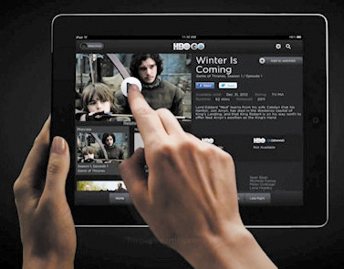 a person touching an ipad displaying entertainment news