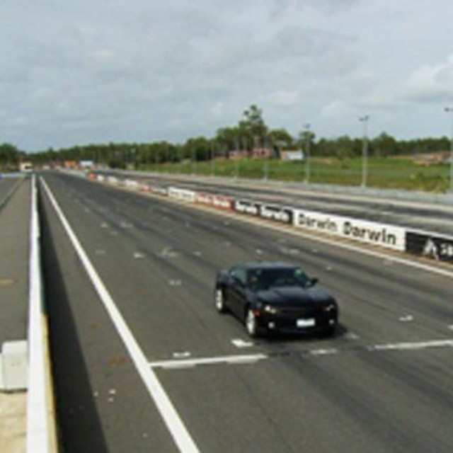 the black car is driving down the highway