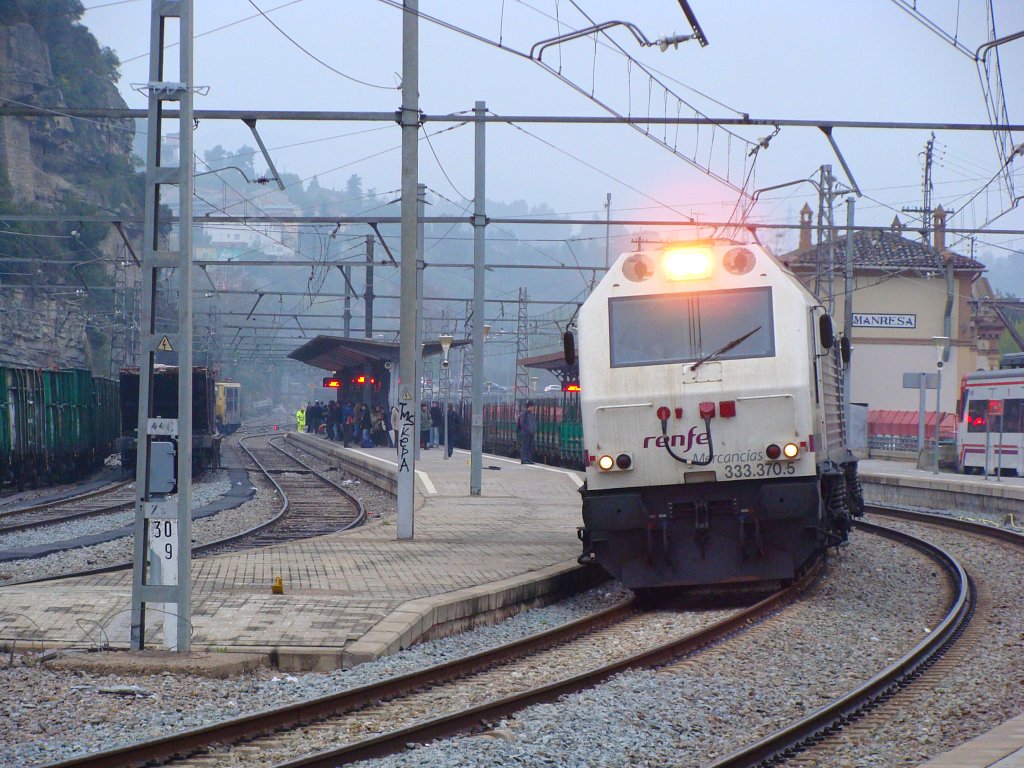 an electric train coming in to a train station