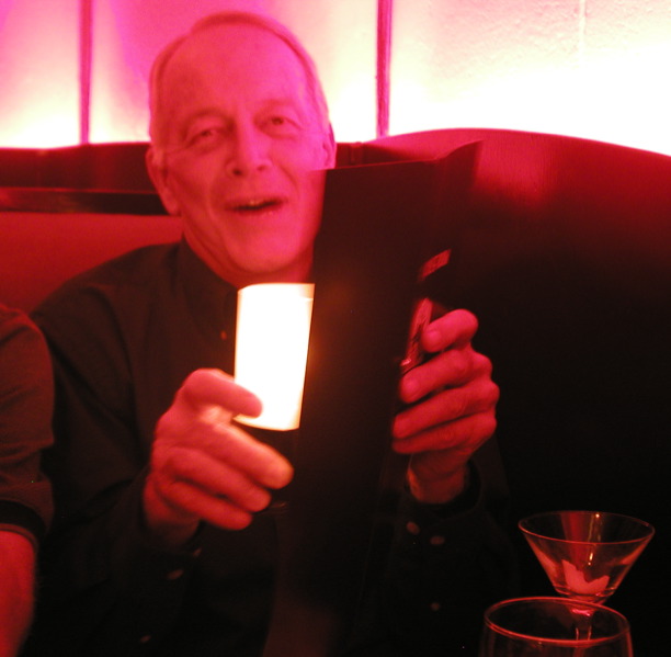 a man is holding up a tablet with the light lit