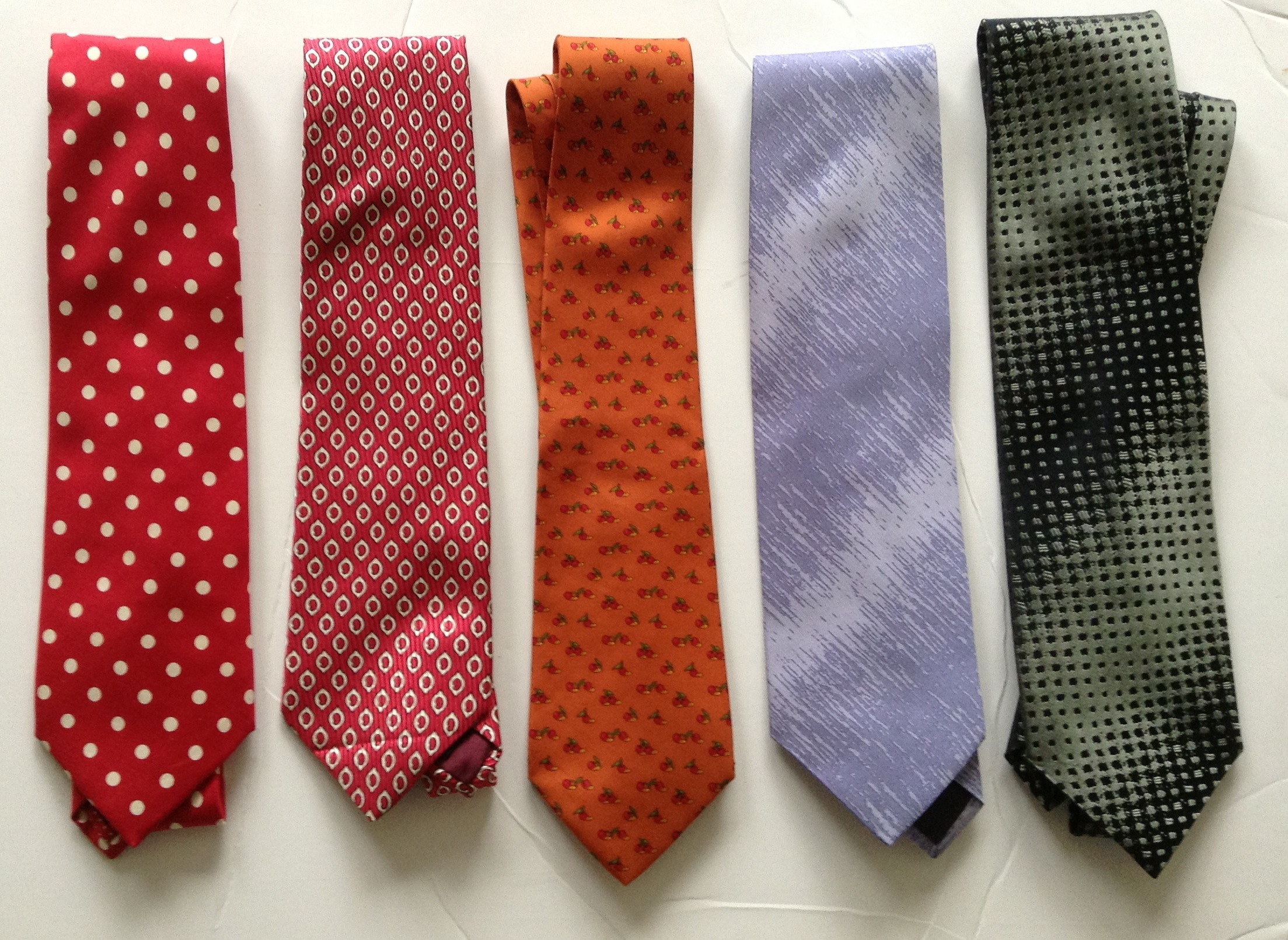 three ties are laid out with one of the four colors in it