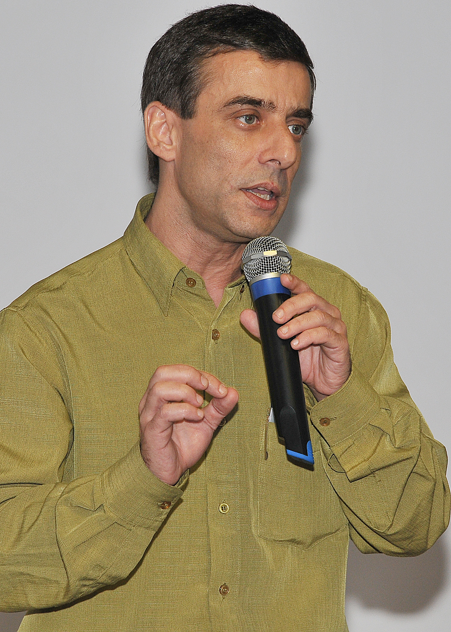 a man holding a microphone speaking to someone