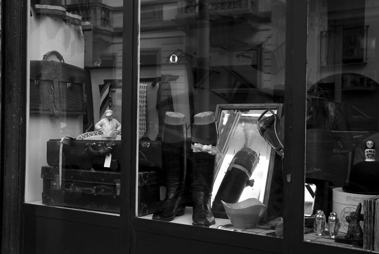 a man sitting in a window of a shop