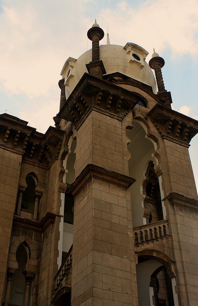 an old building with a clock and some balcony railings