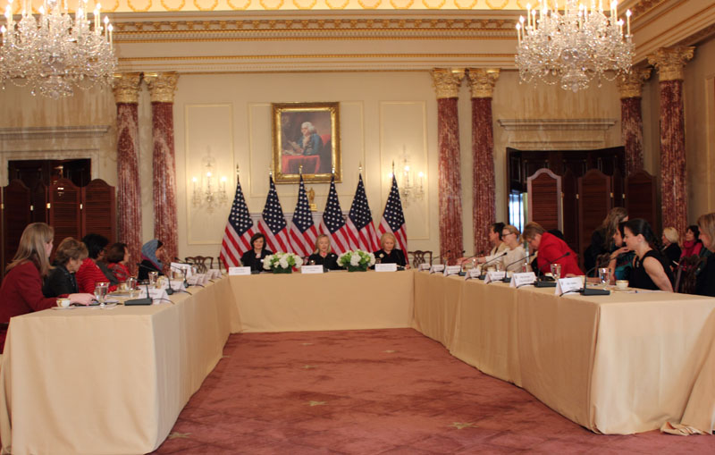 a group of people sitting at tables with us flags in the middle