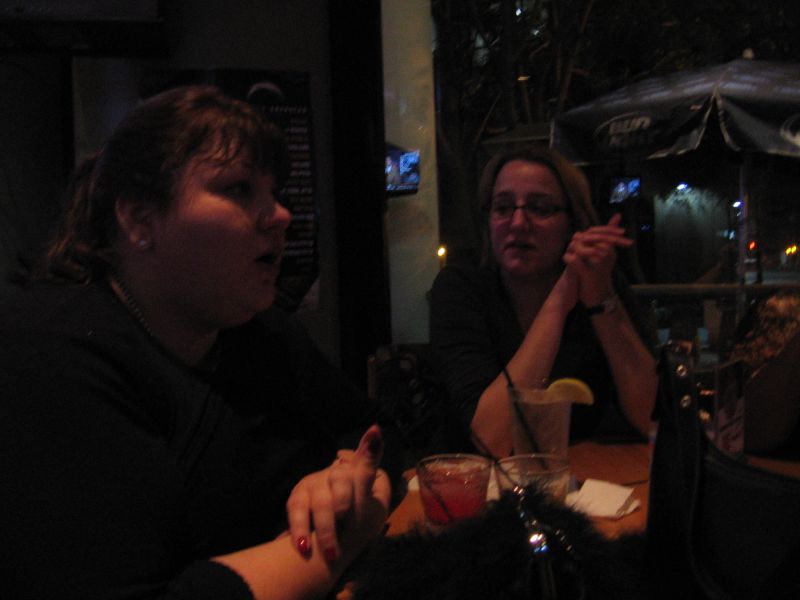 a woman is sitting at a table with another woman