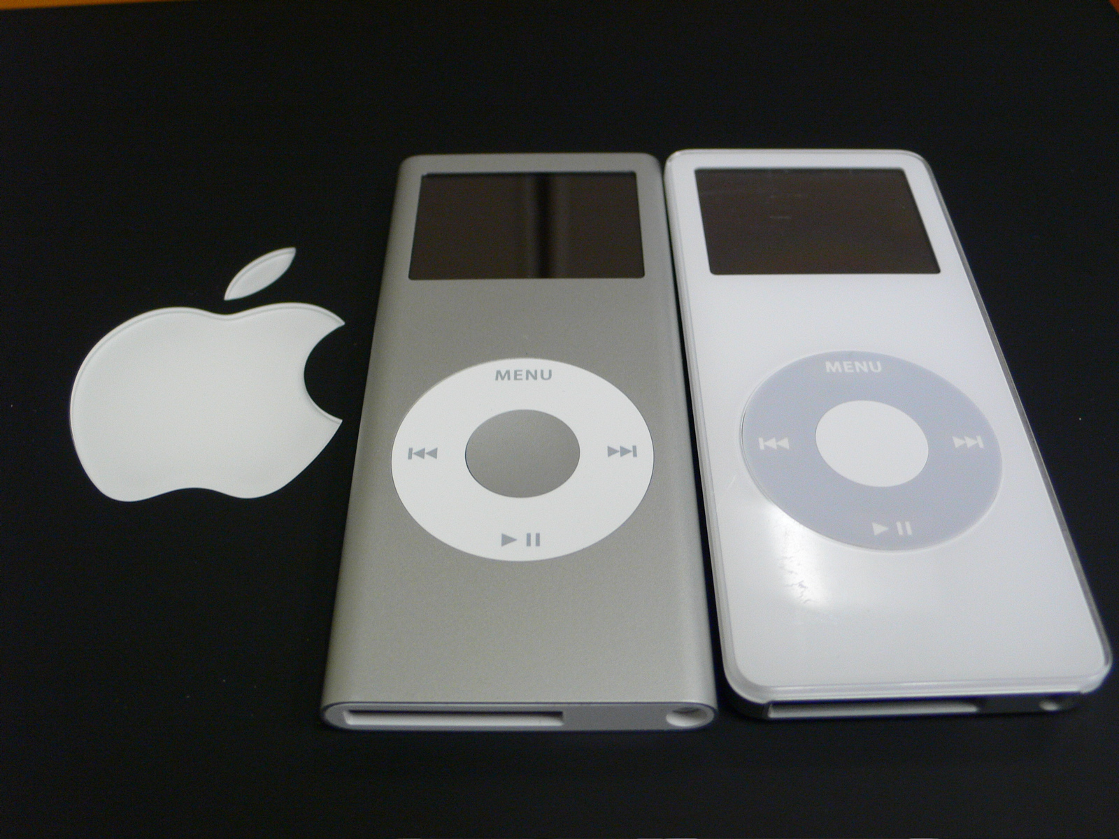 an ipod and an mp3 player lying side by side