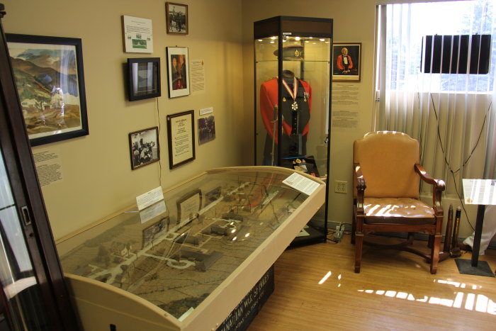 a room with various things on display and several chairs