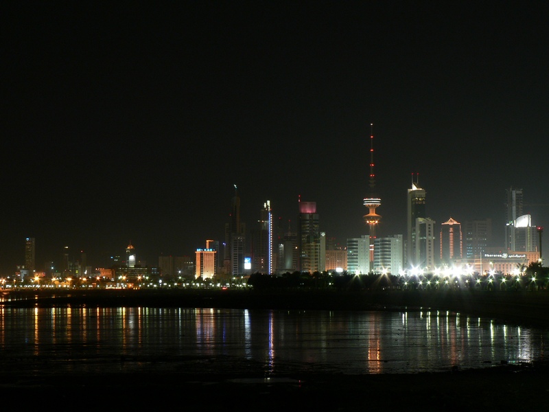 the city at night with lights reflecting on water