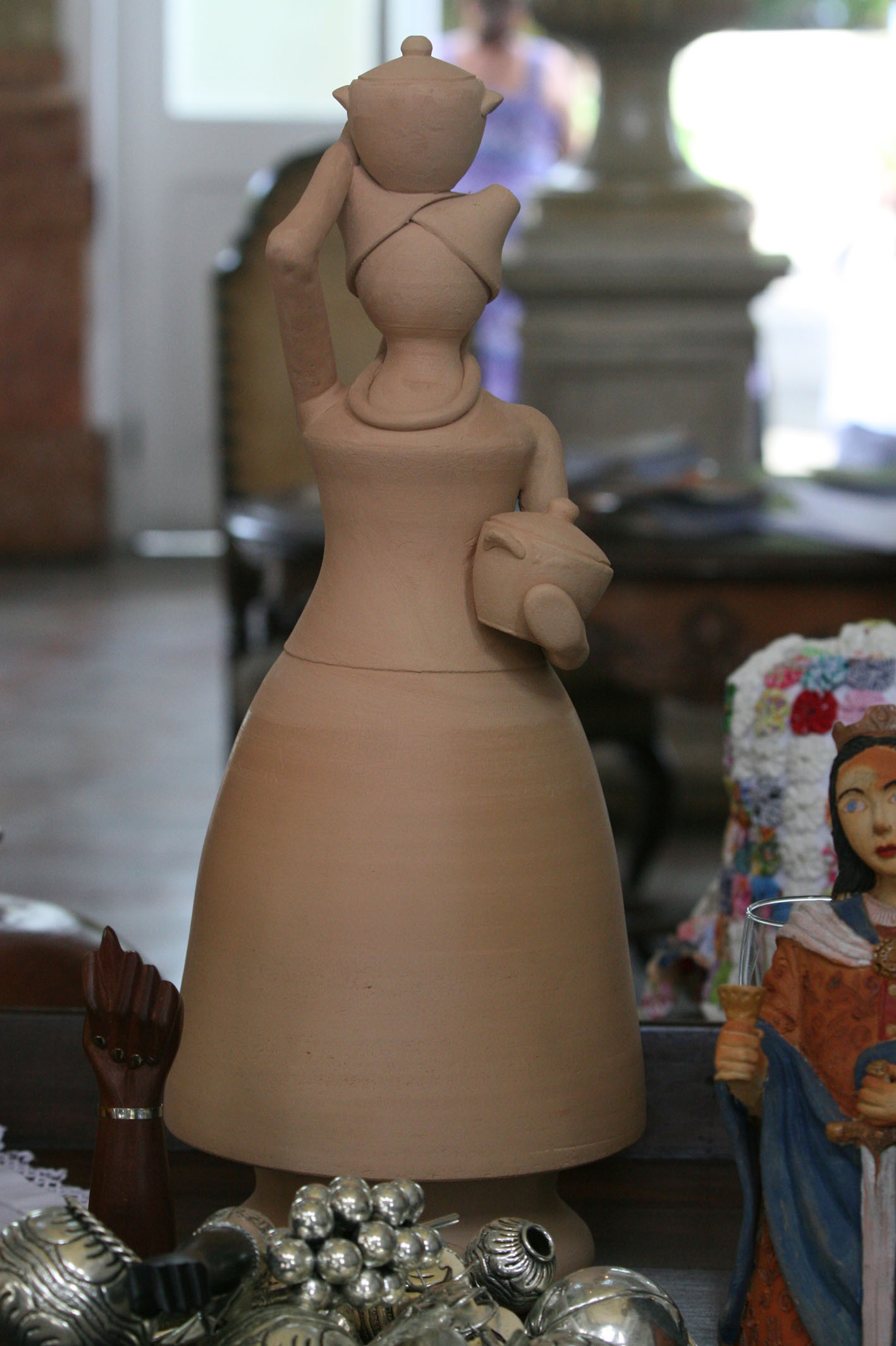 a table covered with several pottery sculptures