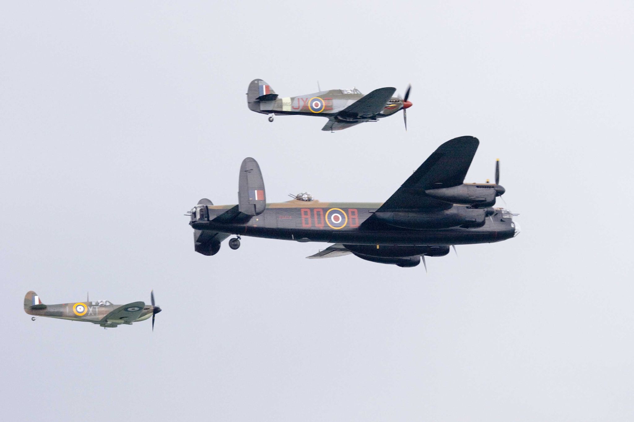 three planes flying in formation on cloudy day