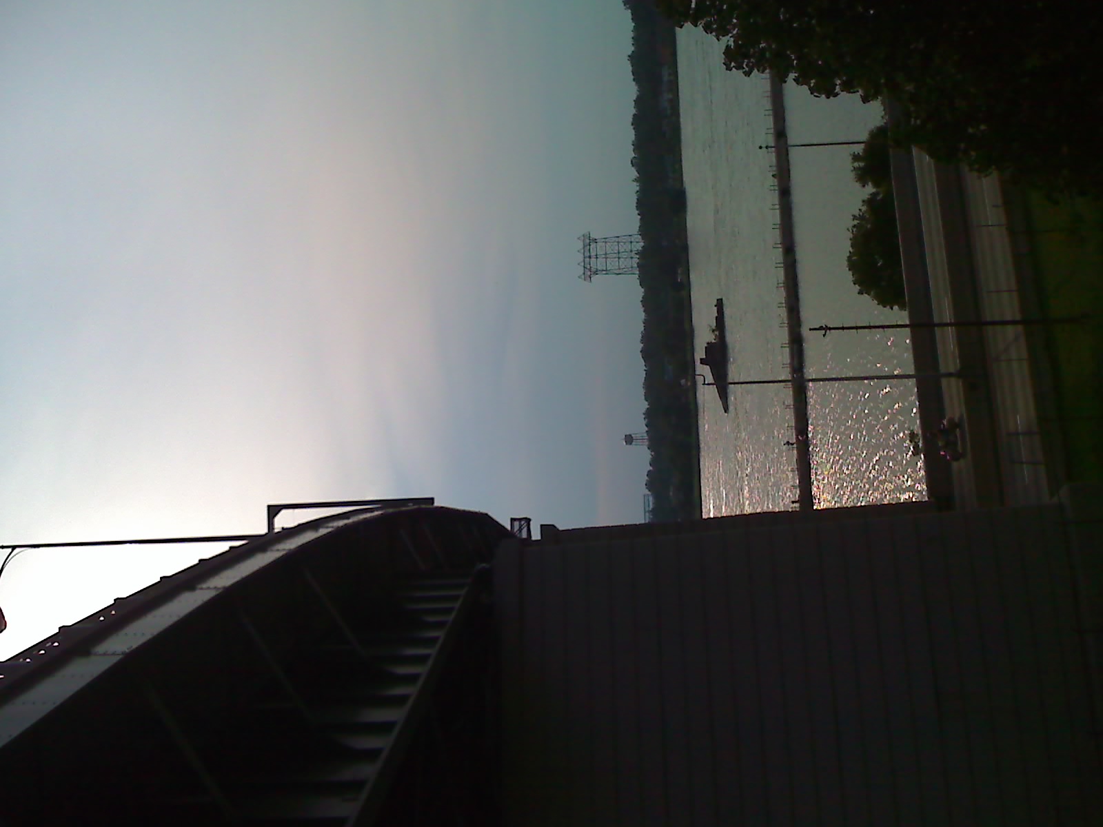 the view of a lake near a large power line