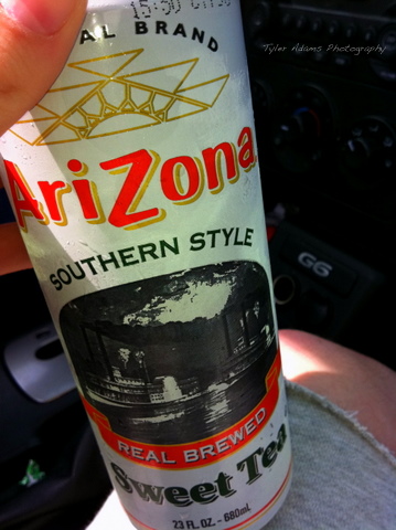 someone holding a bottle of drink that says arizona
