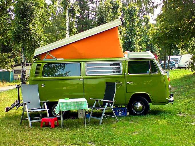an orange tent over the camper van on grass