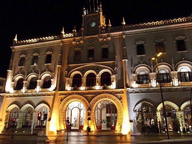 the front of the city hall illuminated at night