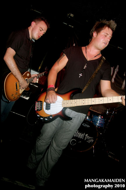 two men are playing guitars on stage