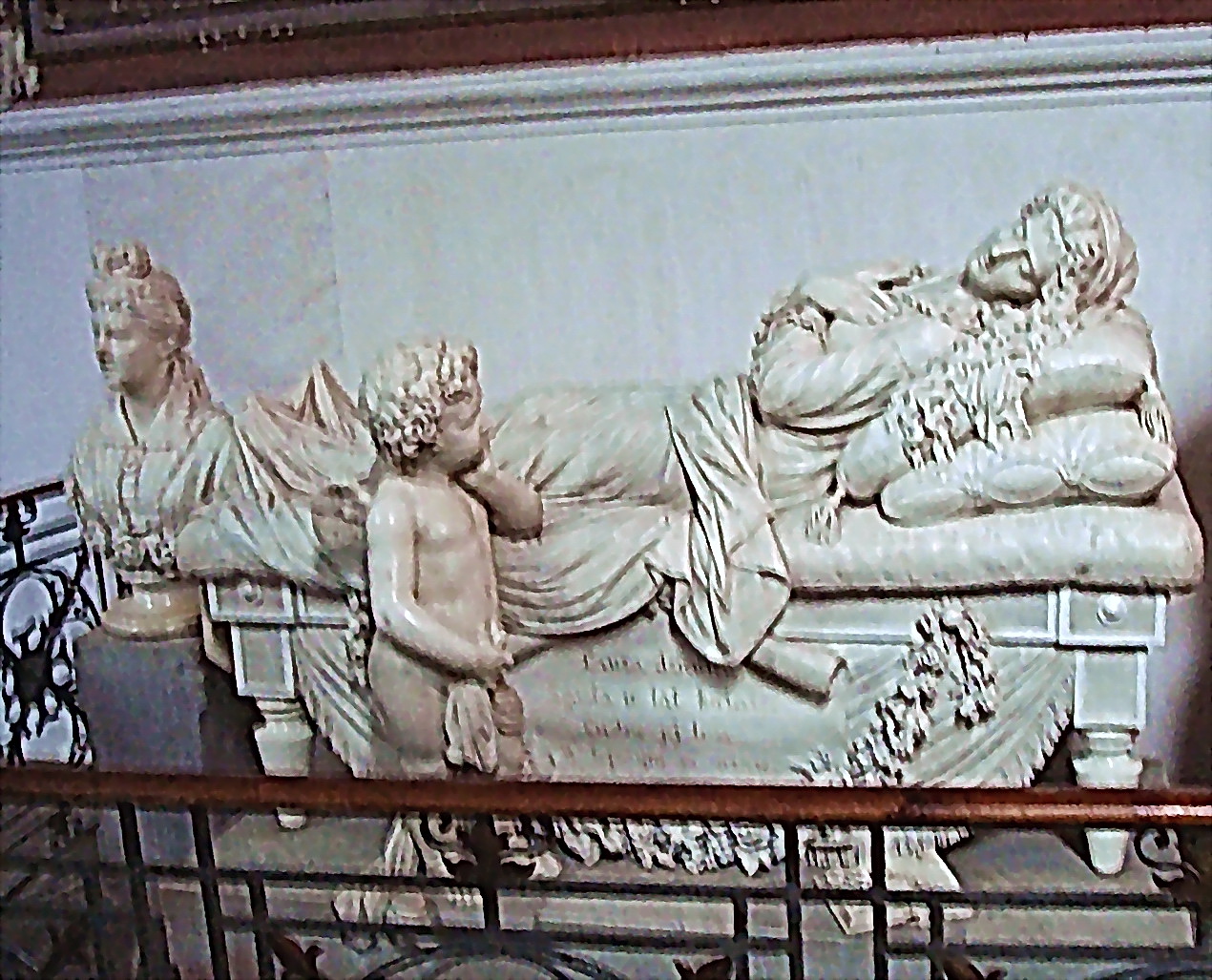 a picture of a statue of a man sleeping on a bed