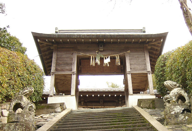 an outdoor shrine with stone steps that leads to it
